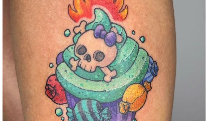 Purple and green cupcake with skull and fire tattoo