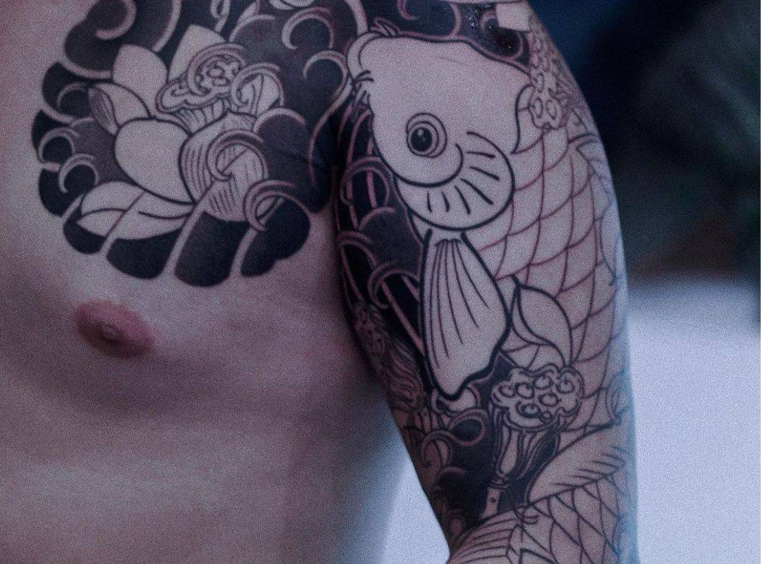 Fish and flower ornament hand tattoo
