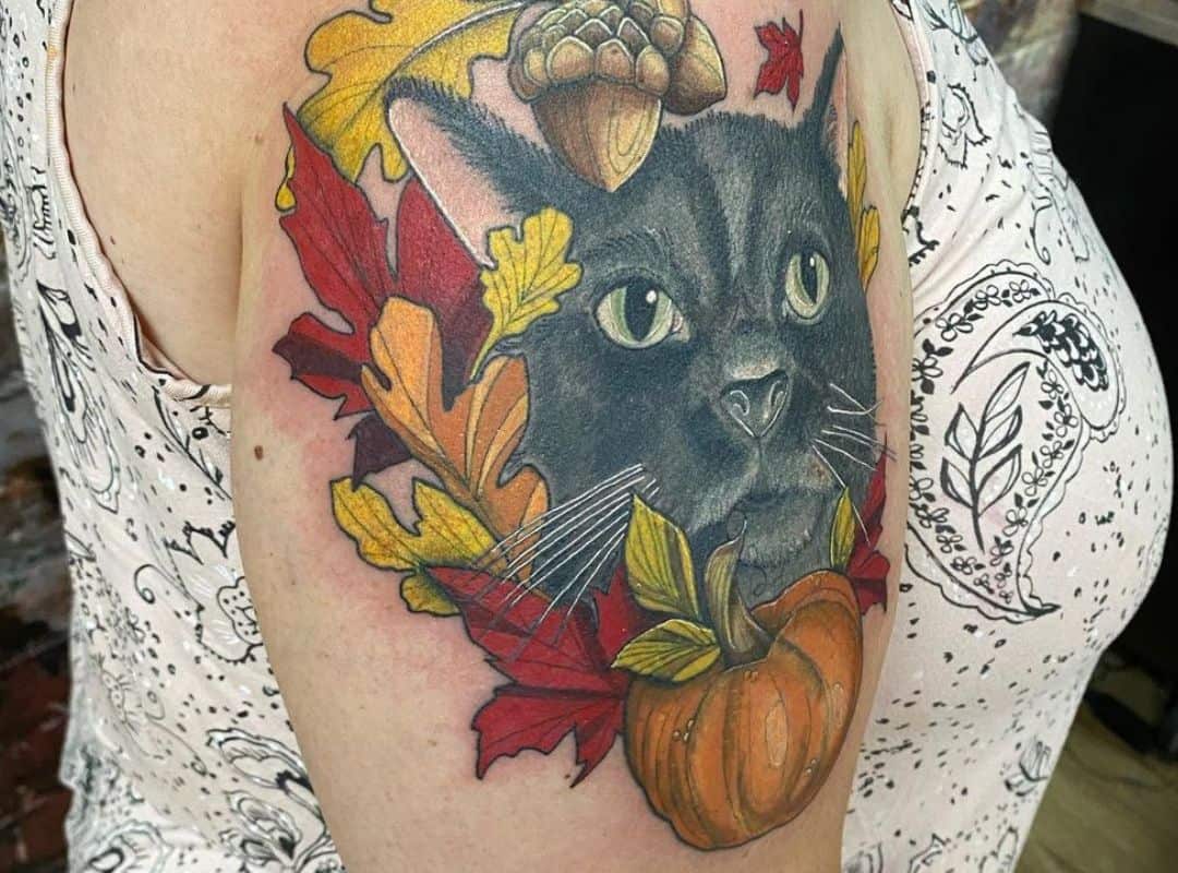 Cat and pumkin with leaves around tattoo