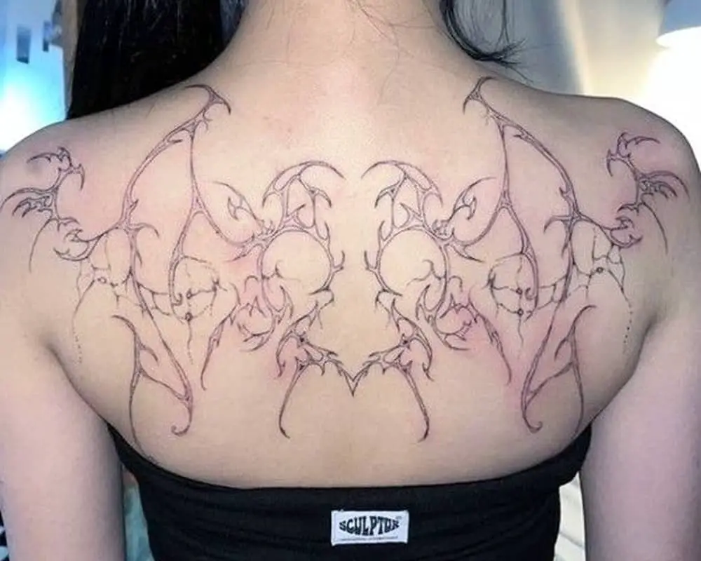 Full-back tattoo in the shape of gothic wings