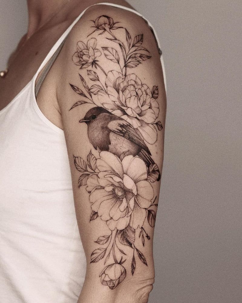Half sleeve tattoo with flowers and a bird