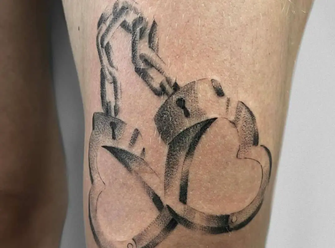Handcuffs with hearts leg tattoo