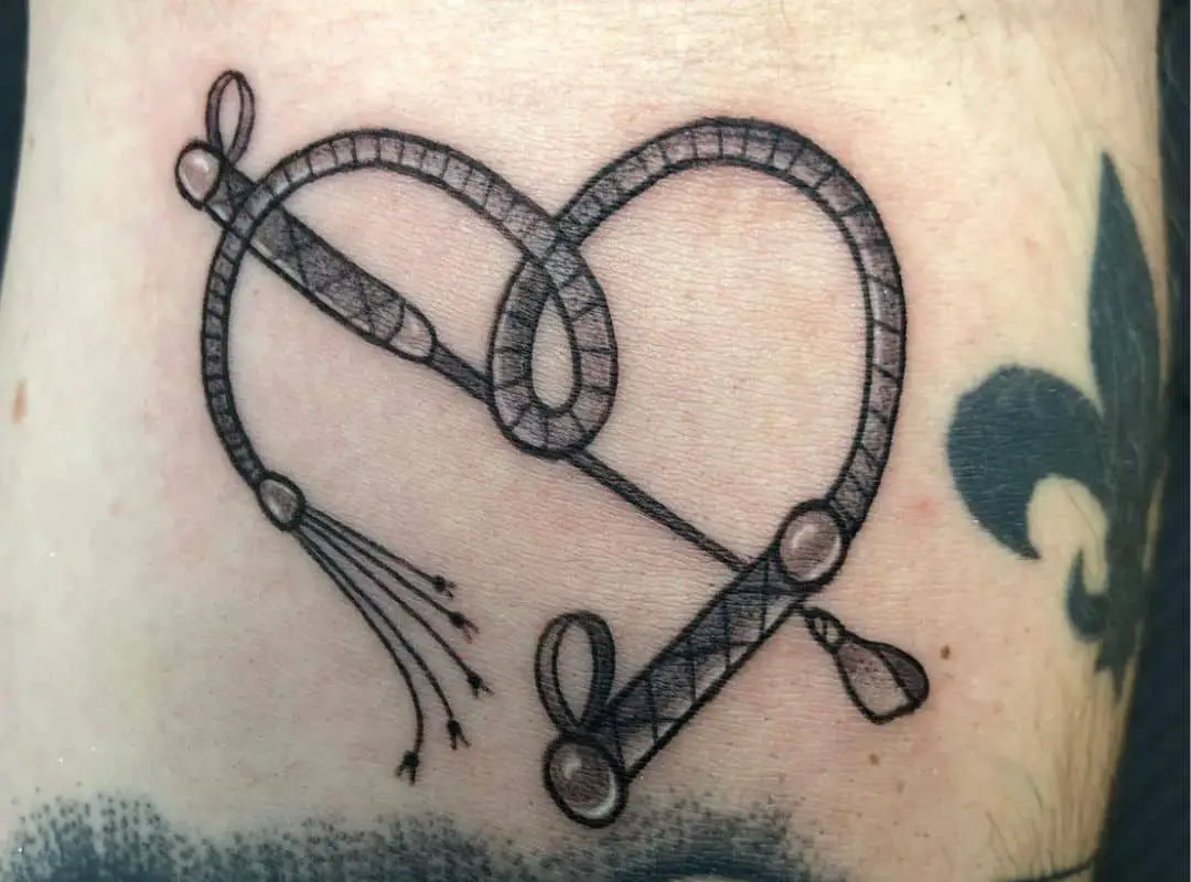 Pointer and heart-shaped braid tattoo