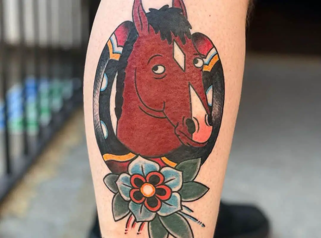 Head of BoJack in horseshoe with flower tattoo