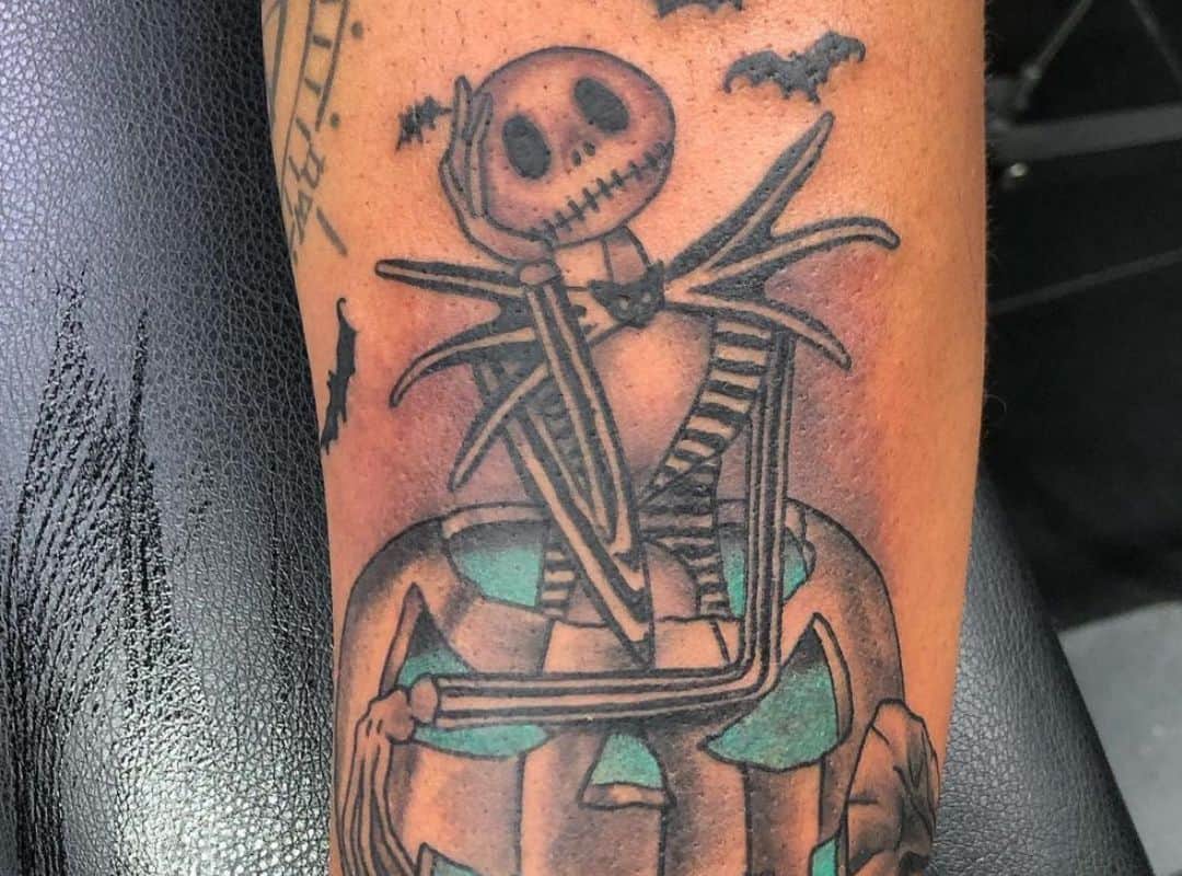 Jack in jack-o-latern and bats around tattoo
