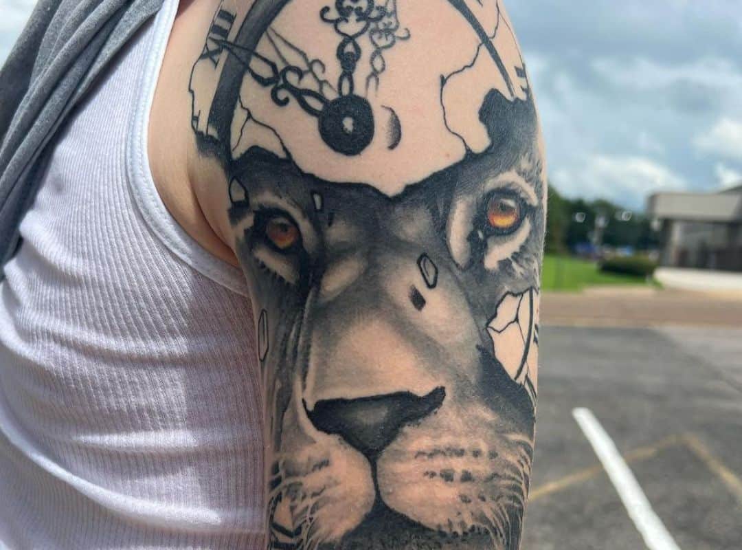The lion's face through the clock tattoo