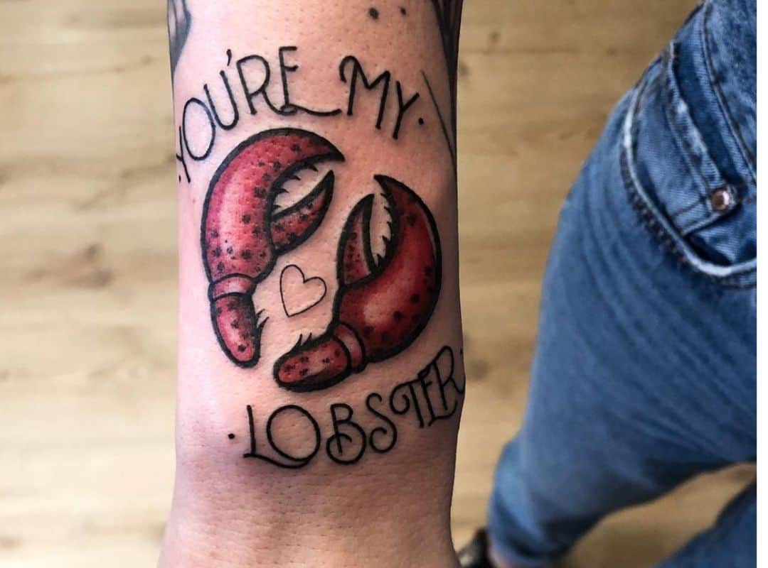 Two lobster claws with heart and sign tattoo