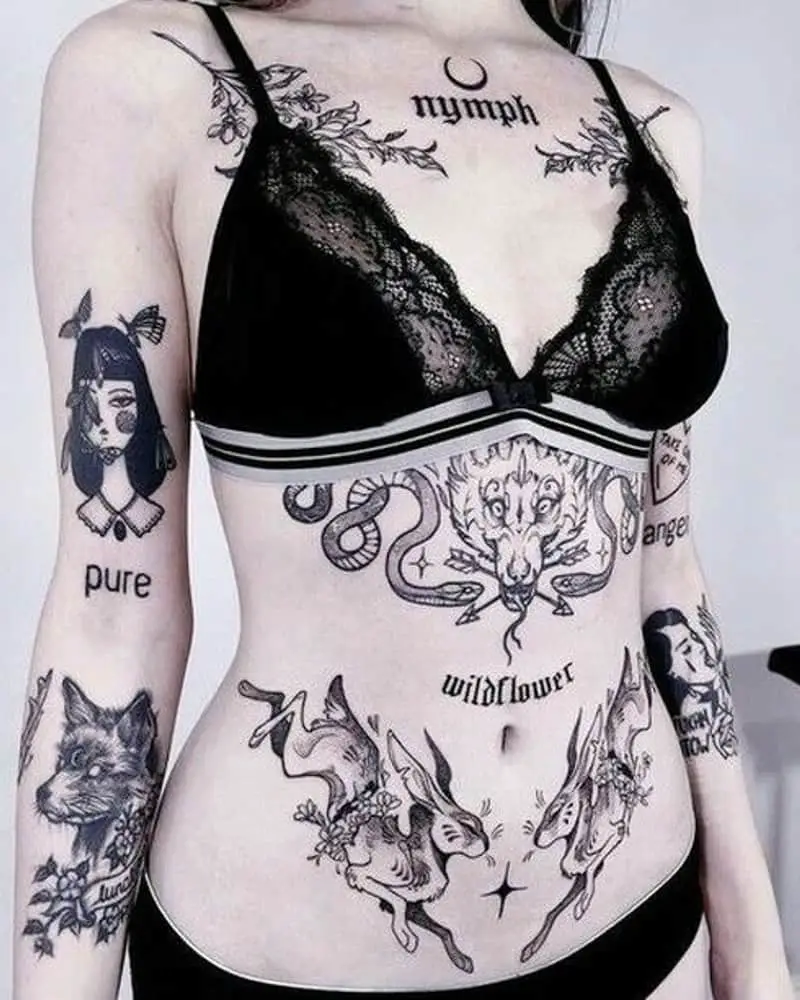 Many tattoos on a woman's body in the form of two rabbits, two snakes, a dragon, a fox and others