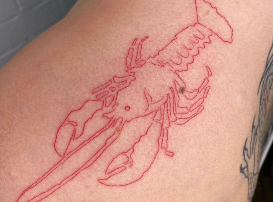 Minimalist red outline lobster tattoo on the shoulder 