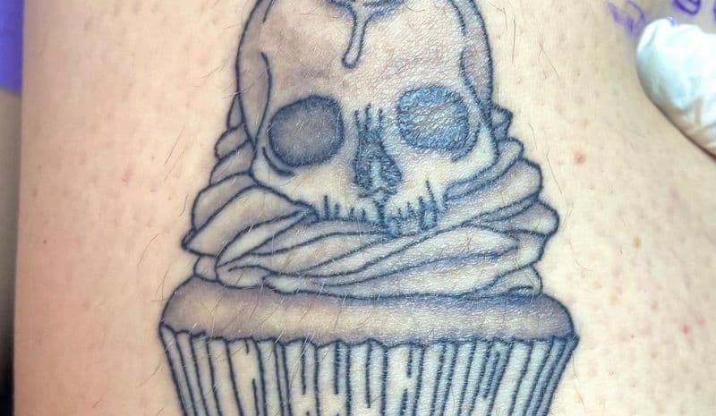 Outline cupcake with the skull on the top tattoo