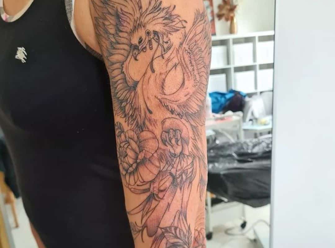 Pheonix with flowers sleeve tattoo