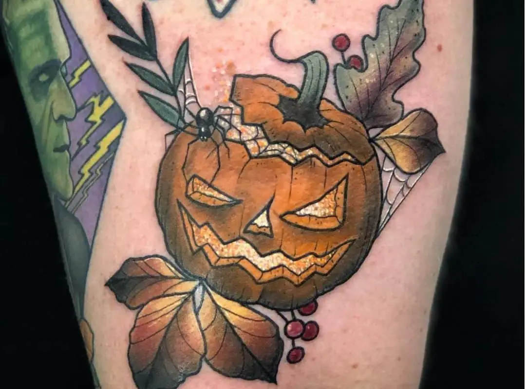 Jack-o-lantern with leaves around tattoo