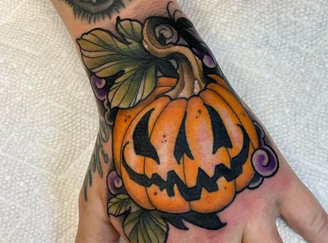 Jack-o-lantern with big leaves tattoo