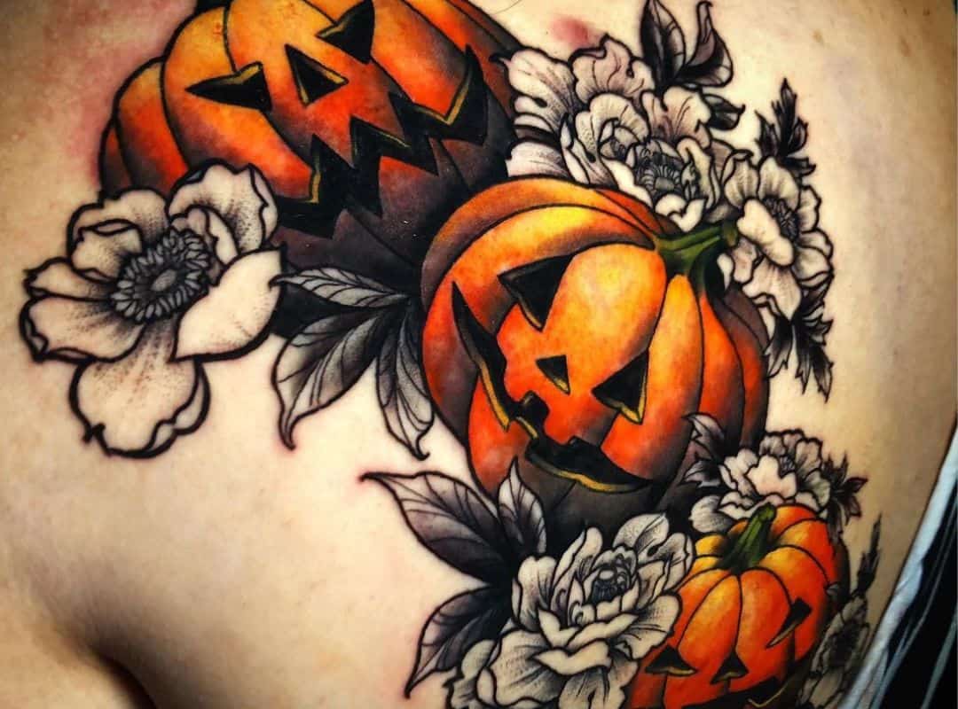 Pumpkins with flowers around tattoo