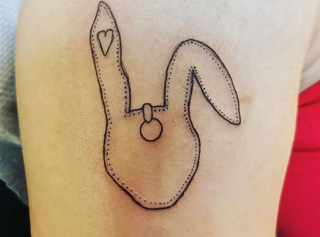 Outline rabbit mask with heart on the ear tattoo
