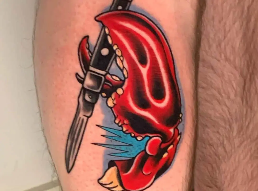Red and black claw with a knife tattoo