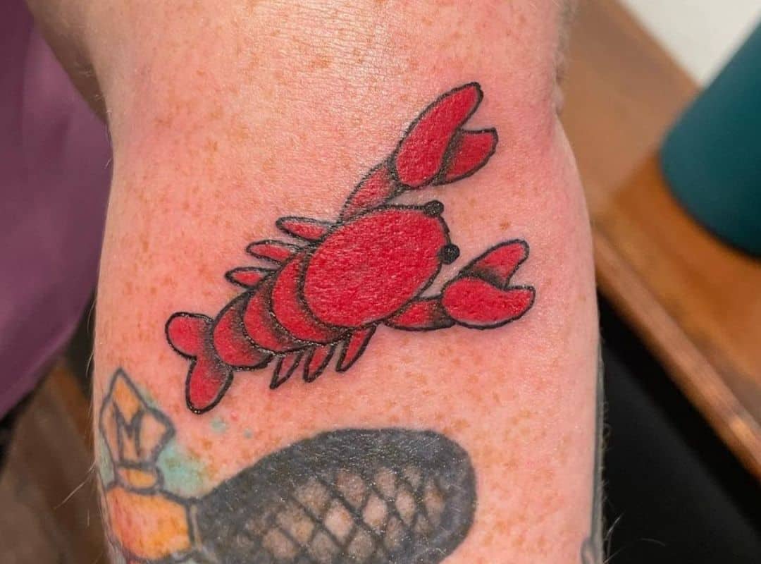 Red lobster tattoo near the elbow