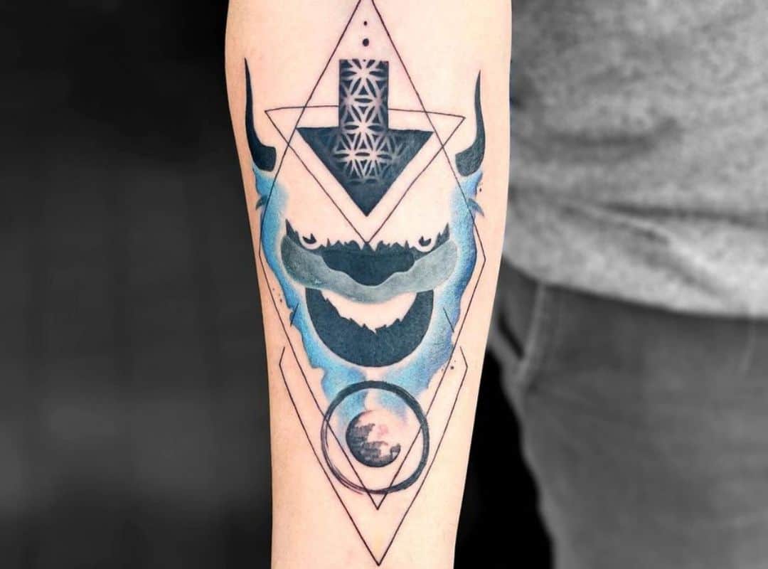 Blue & black Appa face in a rhombus tattoo