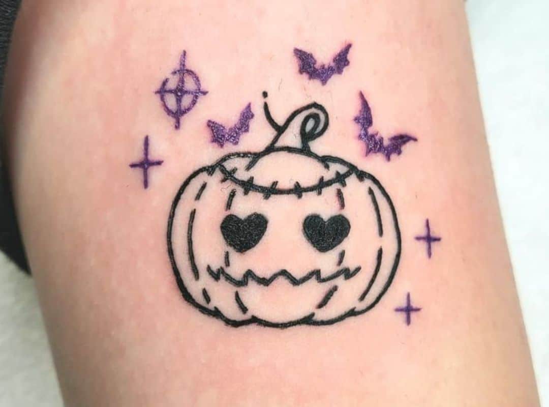 Simple pumkin with eyes hearts and bats around tattoo