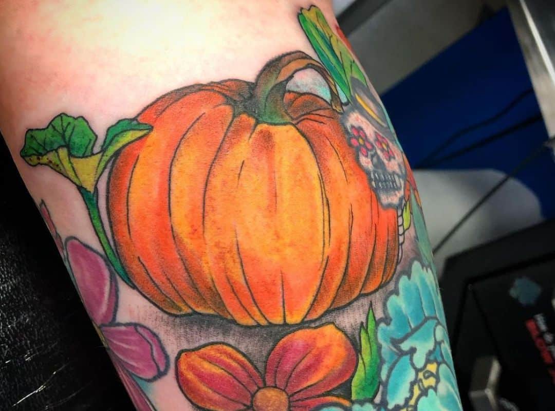 Simple pumpkin with flowers around tattoo