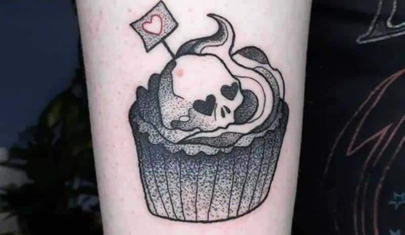 Cupcake with skull and table with heart tattoo