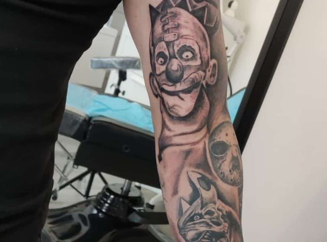 Face in the mask sleeve tattoo