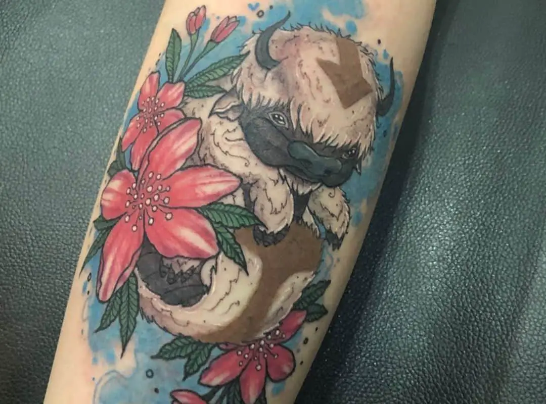 Small Appa with flowers on the blue background tattoo