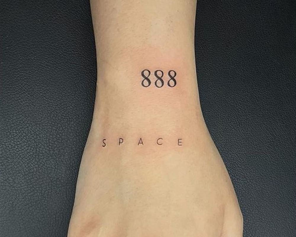 Tattoo 888 on the hand and the inscription space