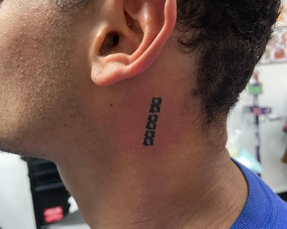 Tattoo 888 on the neck behind the ear