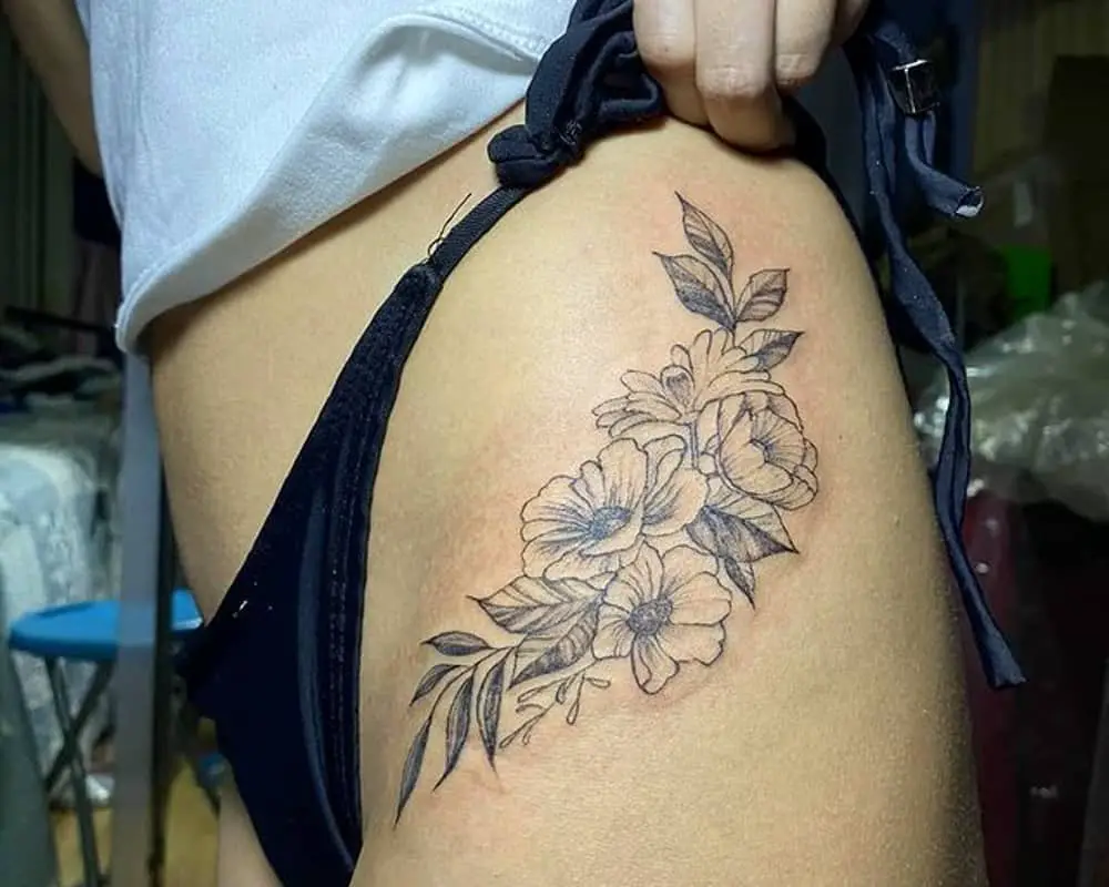Tattoo four large flowers on the thigh