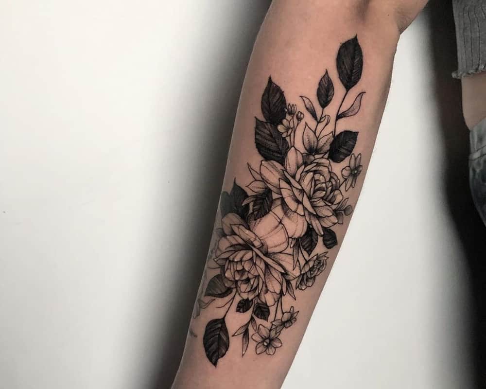 Tattoo in the form of a branch of plants with flower buds