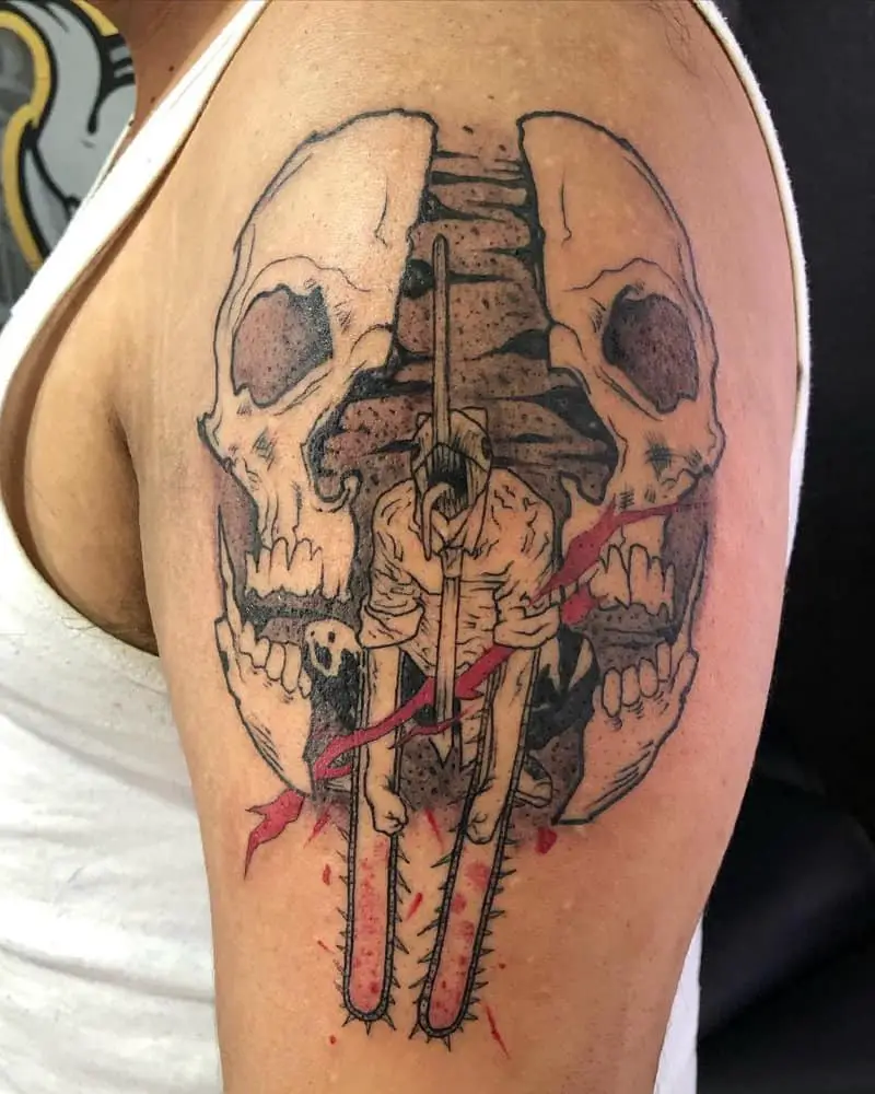 Tattoo in the form of a cut skull and a chainsaw man in the center