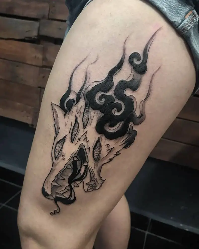 Tattoo in the form of a fox demon with black flames on his leg