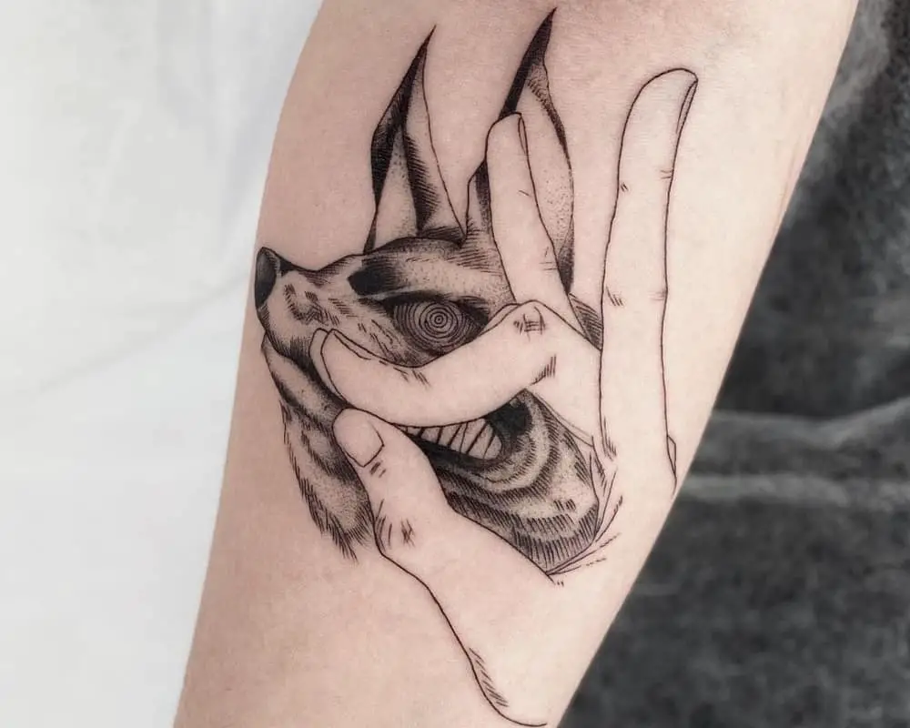 Tattoo in the form of a gesture of a folded hand of Kona and a fox demon