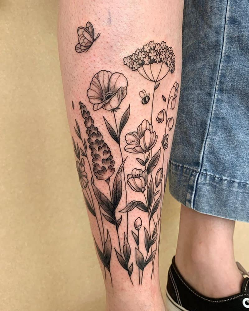 Tattoo in the form of branches of plants and flowers as well as a butterfly
