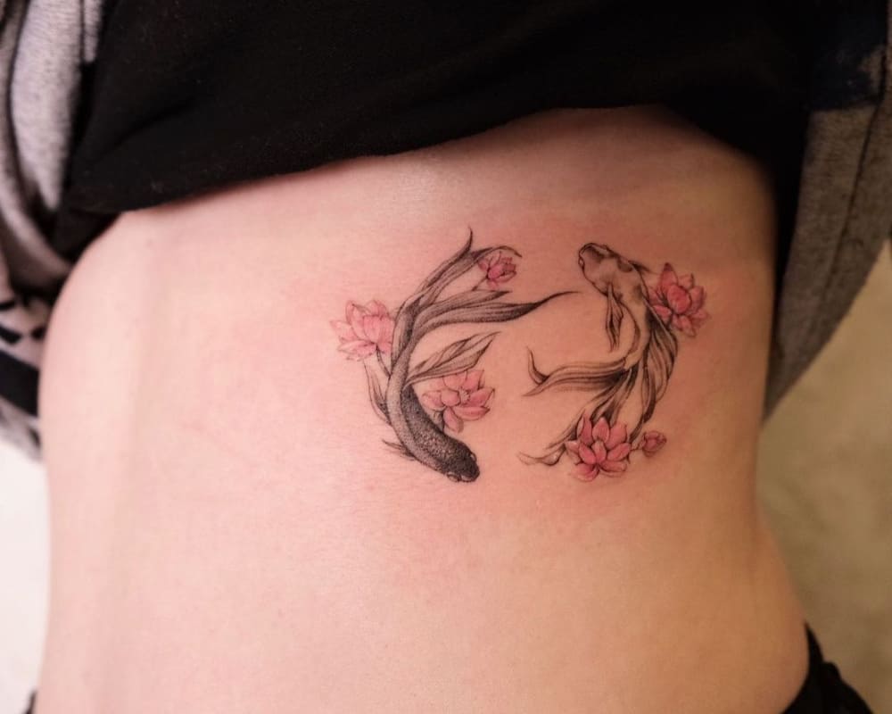 Tattoo in the form of floating Koi fish and flowers