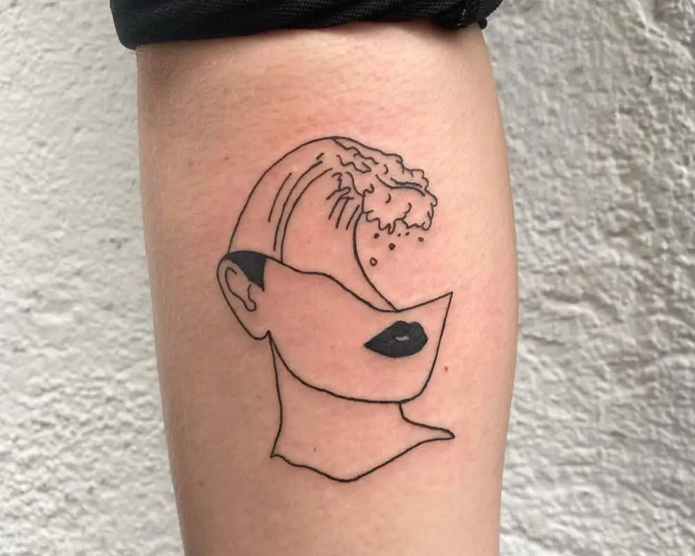 Tattoo in the form of half a head with a wave inside