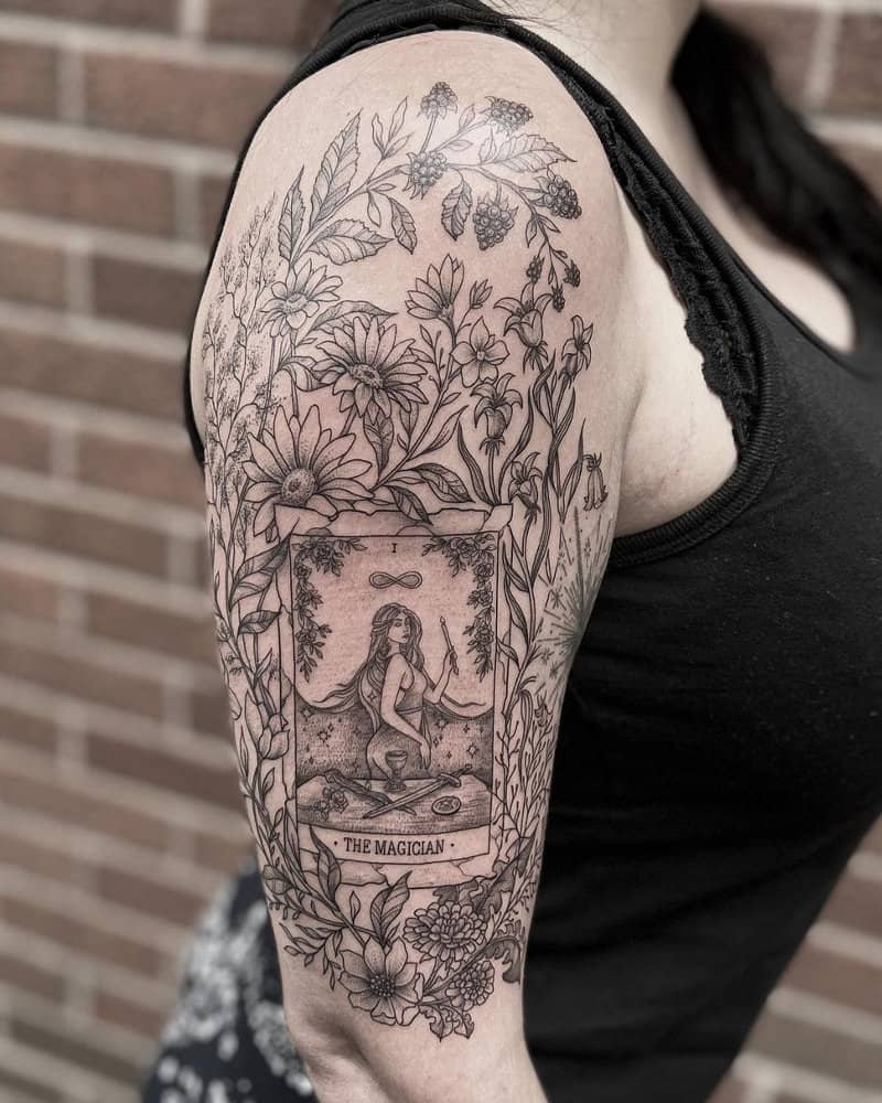 Tattoo in the form of the Magician tarot card surrounded by flowers