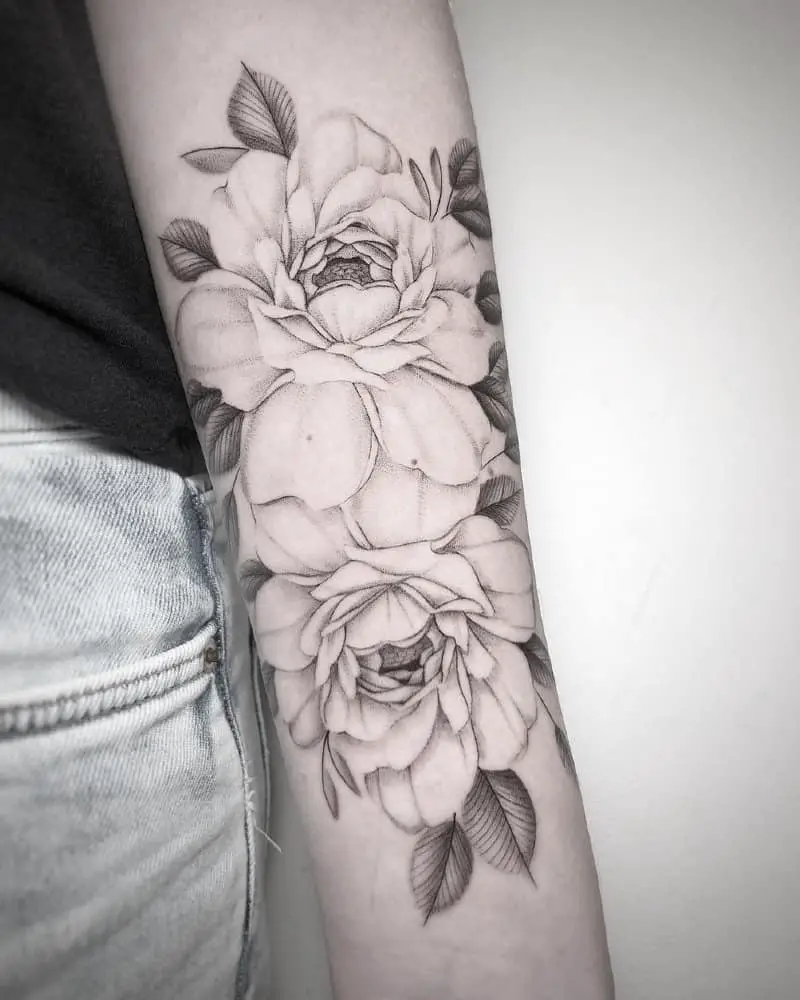 Tattoo in the form of two large buds and leaves on the hand