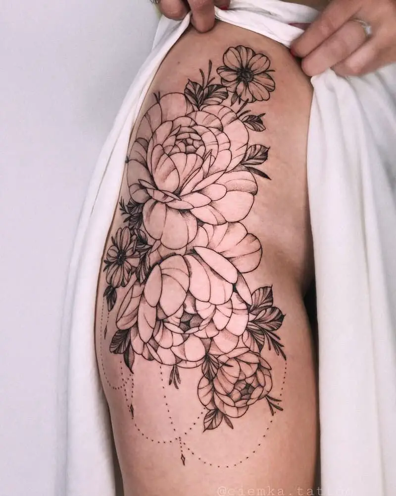 Tattoo in the form of two large buds on the thigh