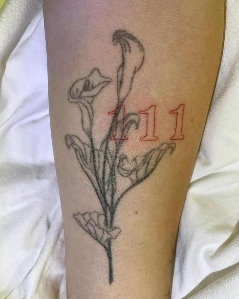 Tattoo of 111 and a branch of flowers