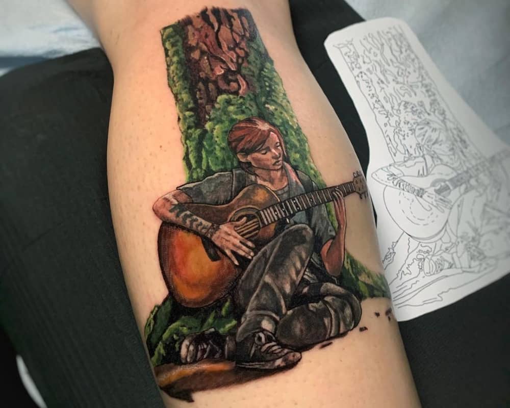 Tattoo of Ellie playing guitar under a tree