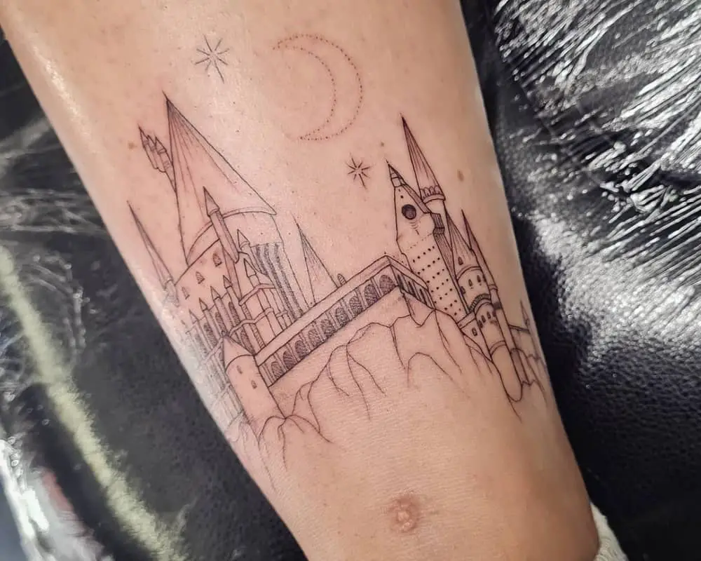 Tattoo of Hogwarts against a background of stars and moon