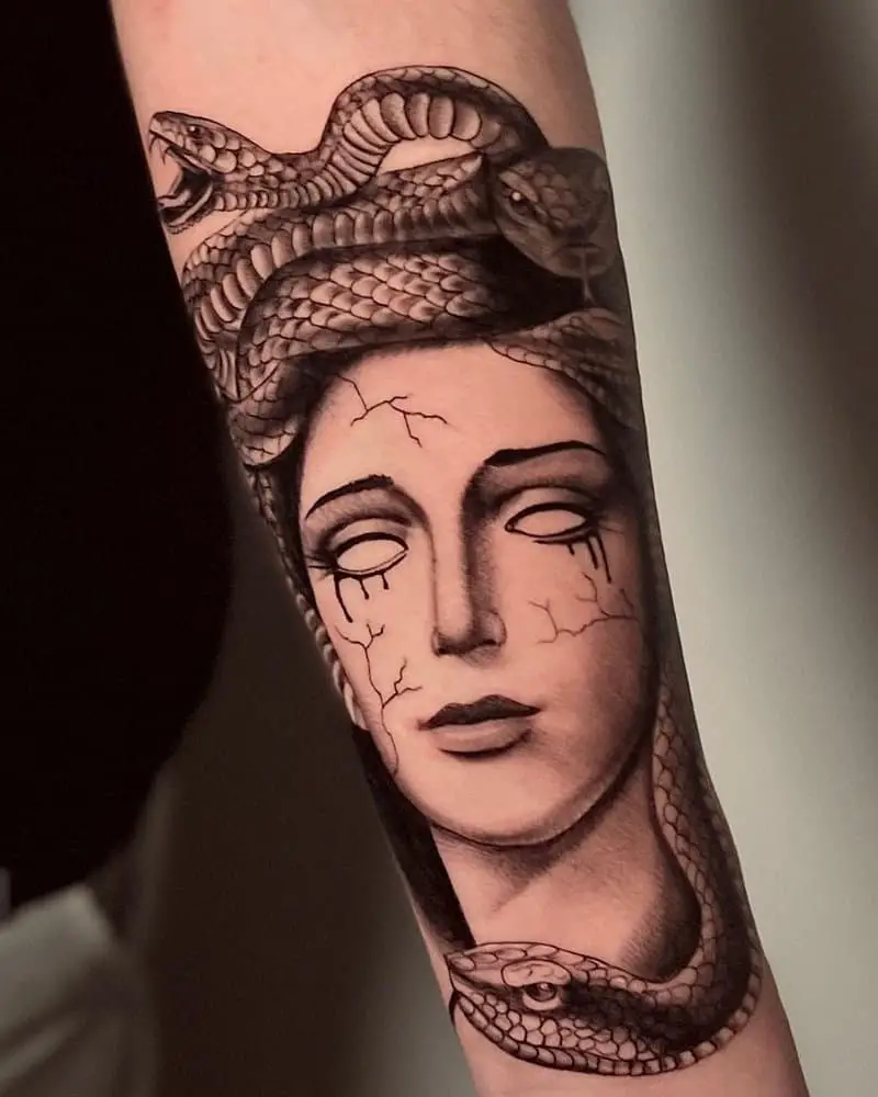 Tattoo of Medusa Gargona with cracks on her face and bloody tears