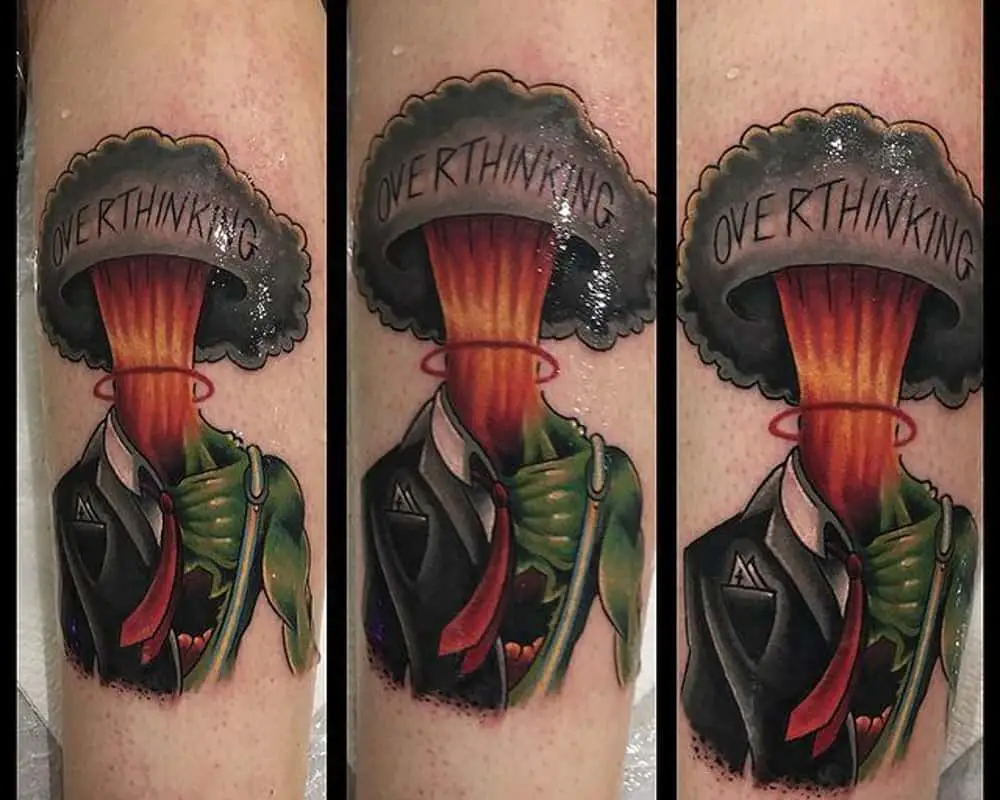 Tattoo of a body in a suit and instead of a head a mushroom from an explosion with the inscription overthinking