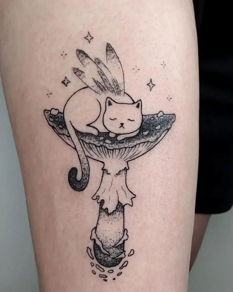 Tattoo of a cat with wings sleeping on a large mushroom