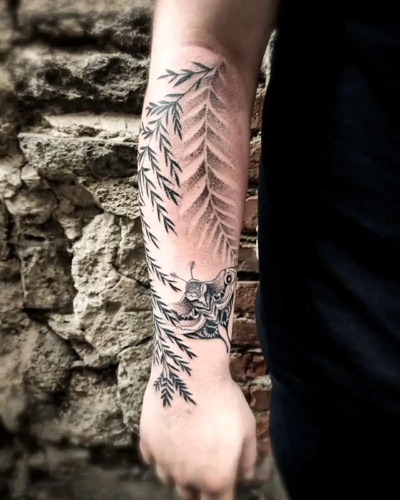 Tattoo of a cicada and plant branches