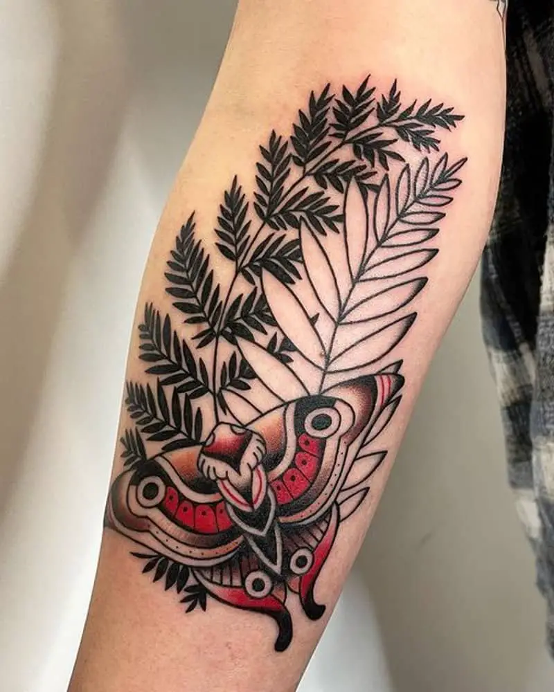 Tattoo of a cicada on plant branches