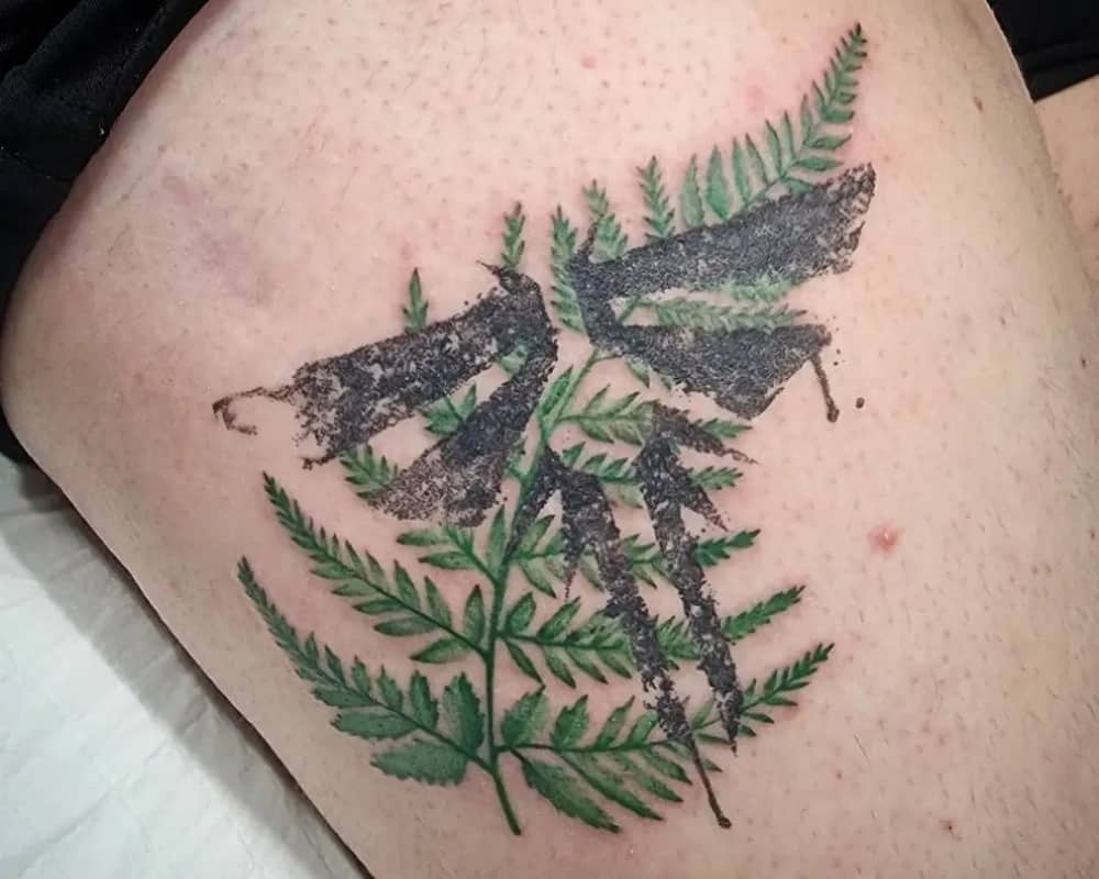 Tattoo of a cicada sign on the branches