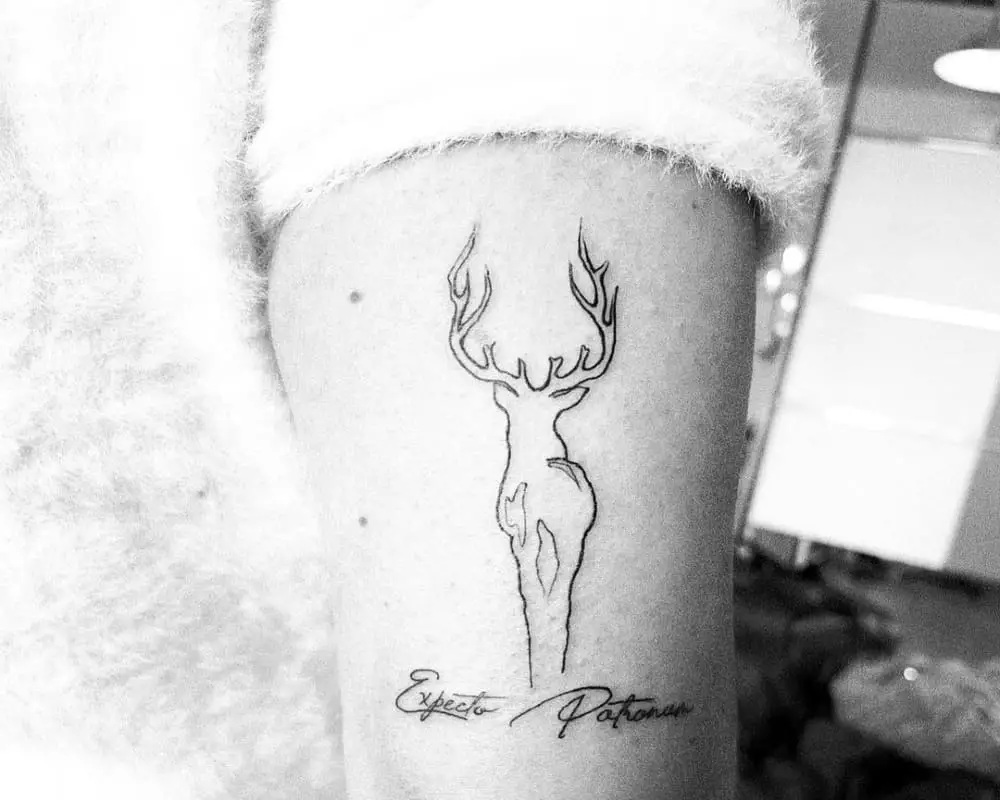 Tattoo of a deer and the inscription Especto Patronum